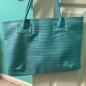 Light Blue Thin Tote Bag with interior zipper pockets and two other pockets.